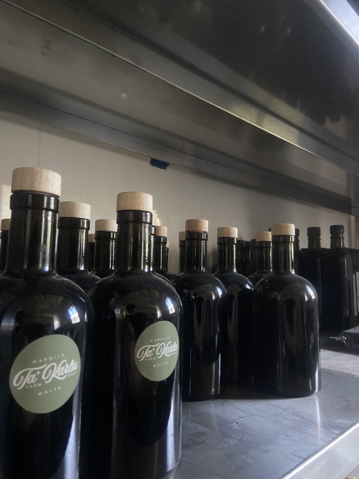 Ta' Karlu olive oil bottles with the farm seal